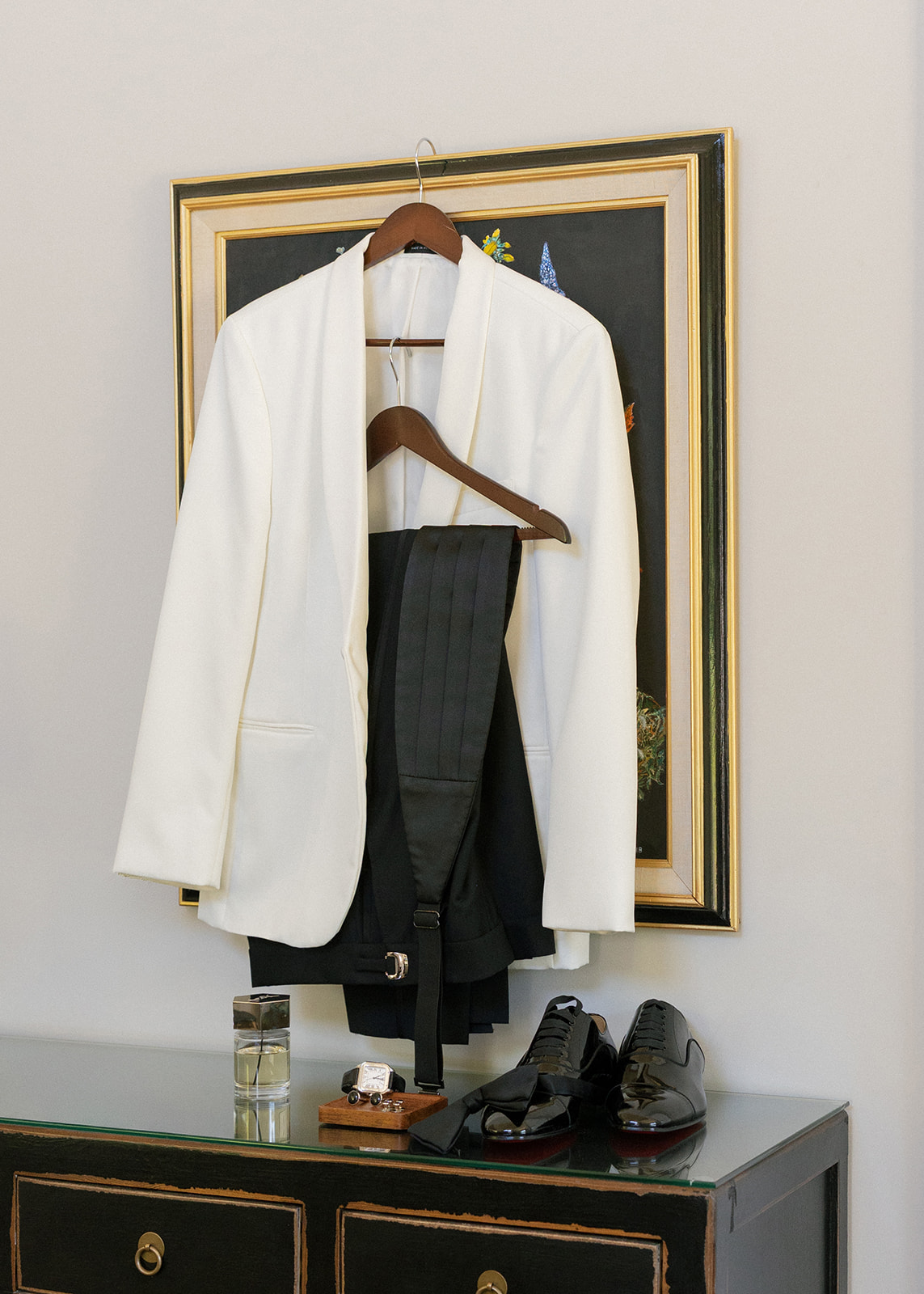 Groom’s white dinner jacket, black trousers, and dress shoes arranged at Silverado Resort in Napa.