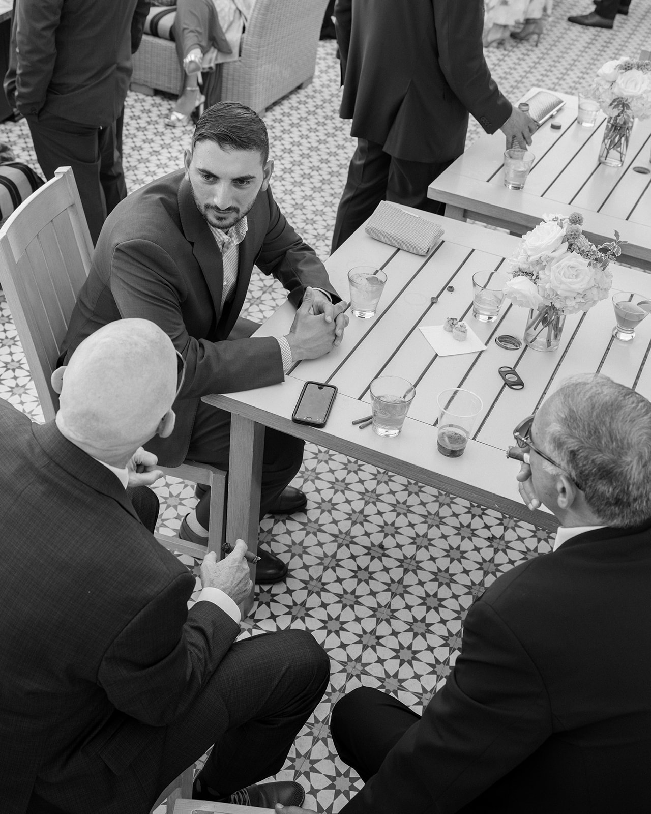Wedding guests gather around a table with cigars at Silverado Resort in Napa.
