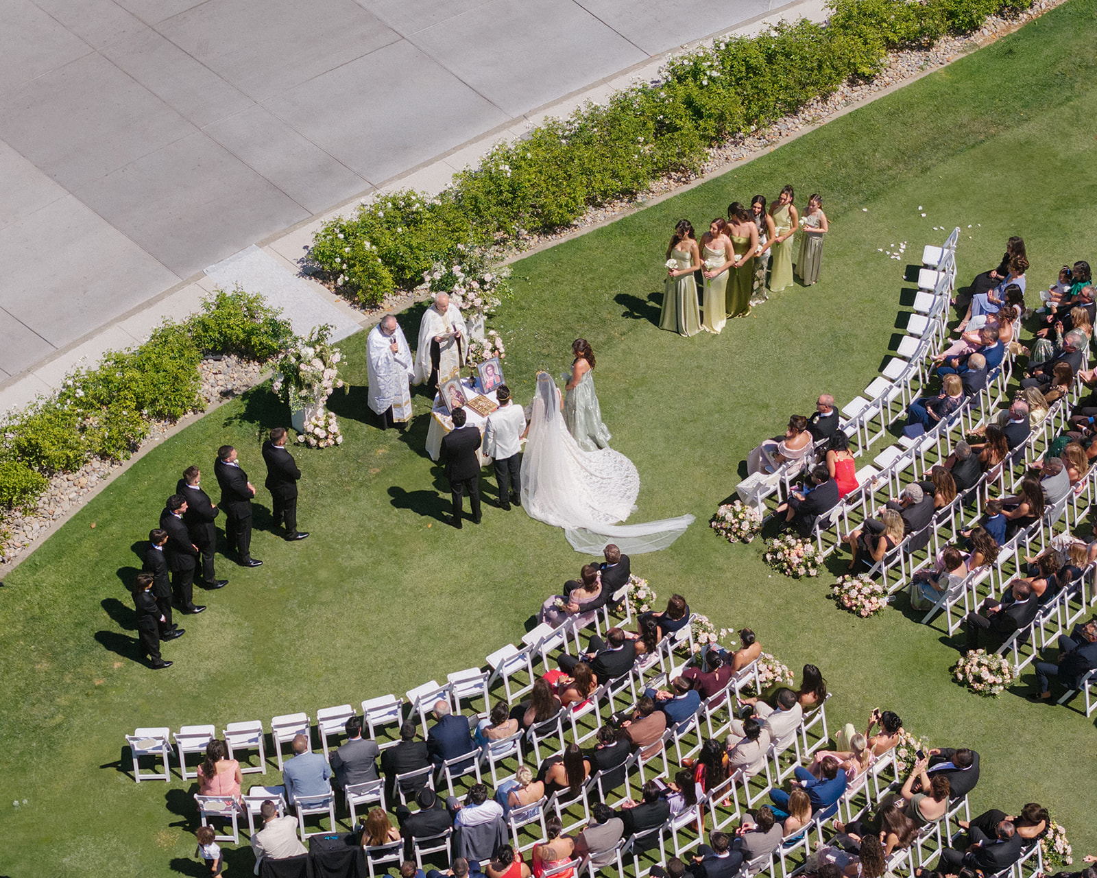 Aerial view of the bride and groom at their outdoor ceremony with guests and the wedding party at Silverado Resort in Napa.