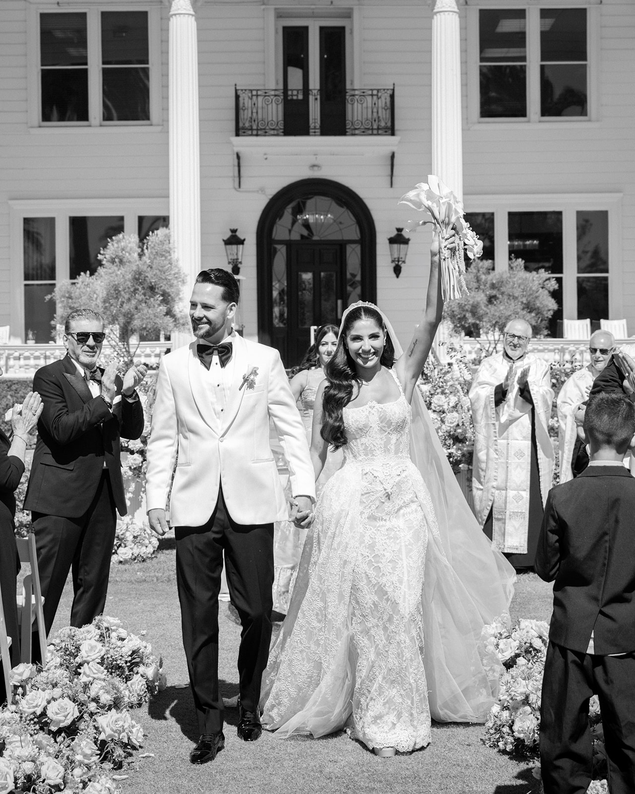 Newlyweds walk up the aisle between standing guests after their ceremony at Silverado Resort in Napa.
